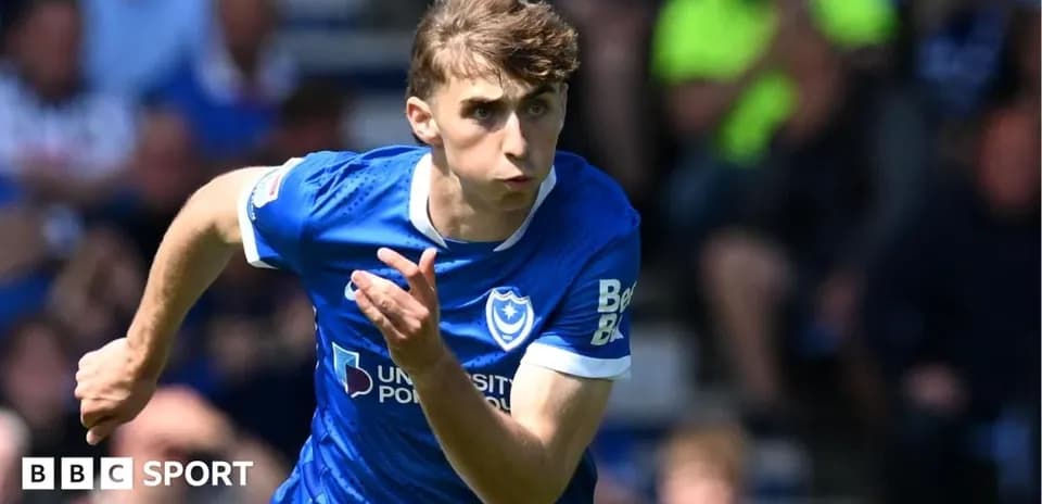 Jugador de Portsmouth corriendo con balón en el campo
