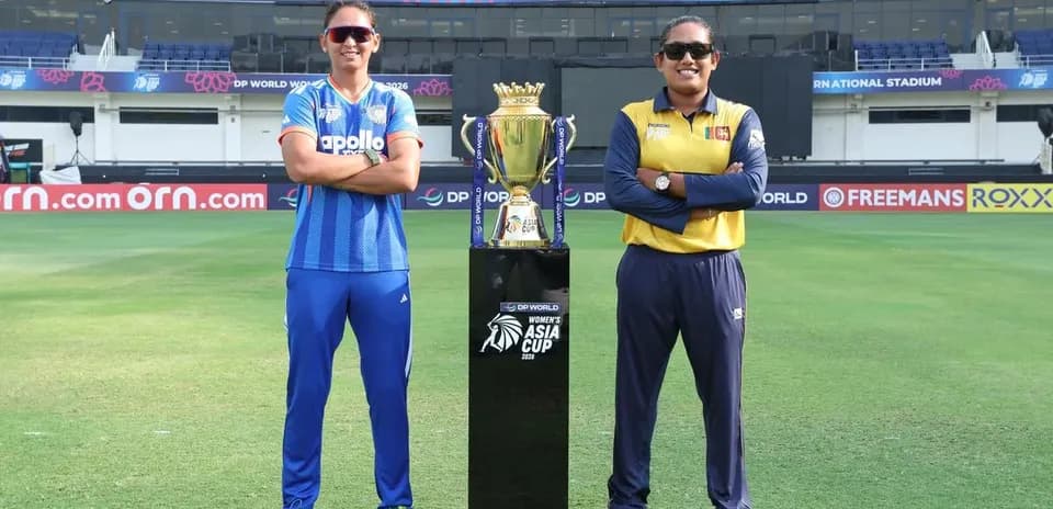 Capitanas de cricket posando con trofeo en estadio
