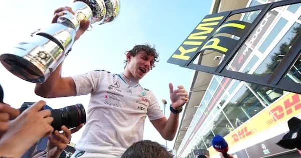 Piloto celebrando con trofeo en el podio