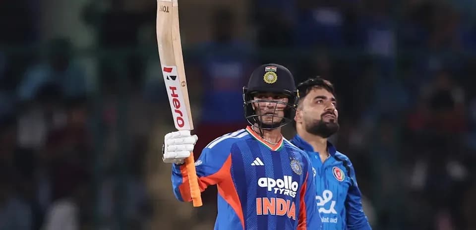 Batsman celebrating with raised bat during match