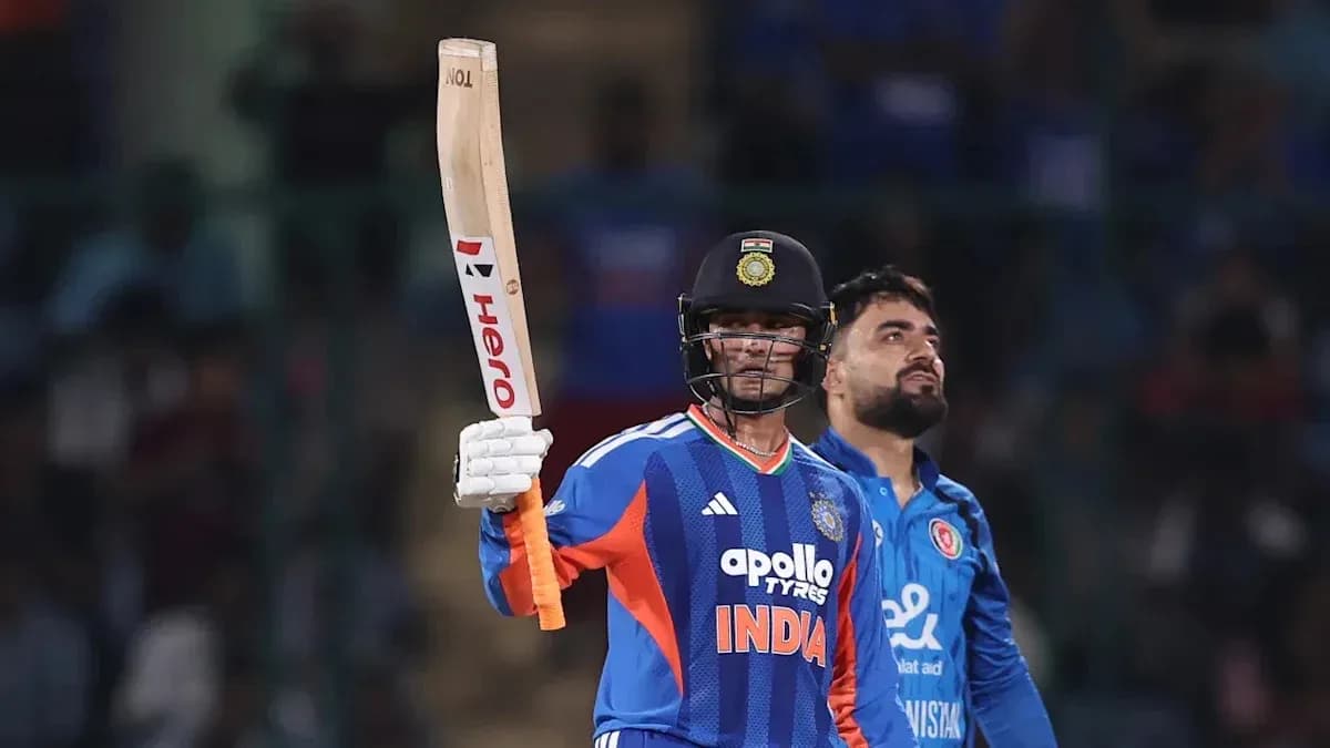 Batsman celebrating with raised bat during match