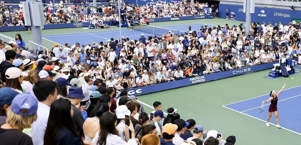 Jugadora de tenis sirviendo en un torneo lleno