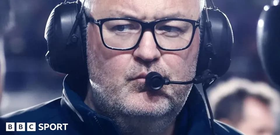 Entrenador con auriculares en el campo de juego