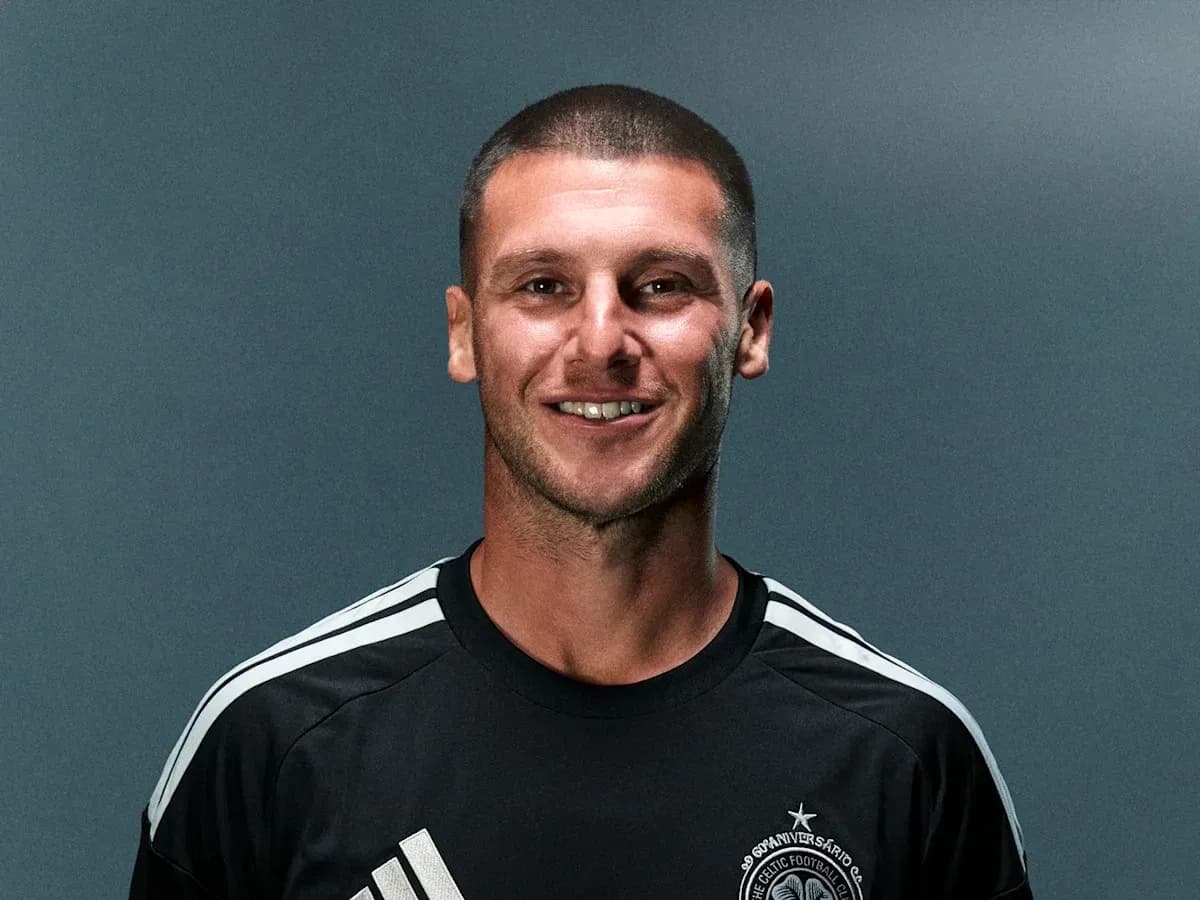 Jugador sonriendo con camiseta negra de equipo