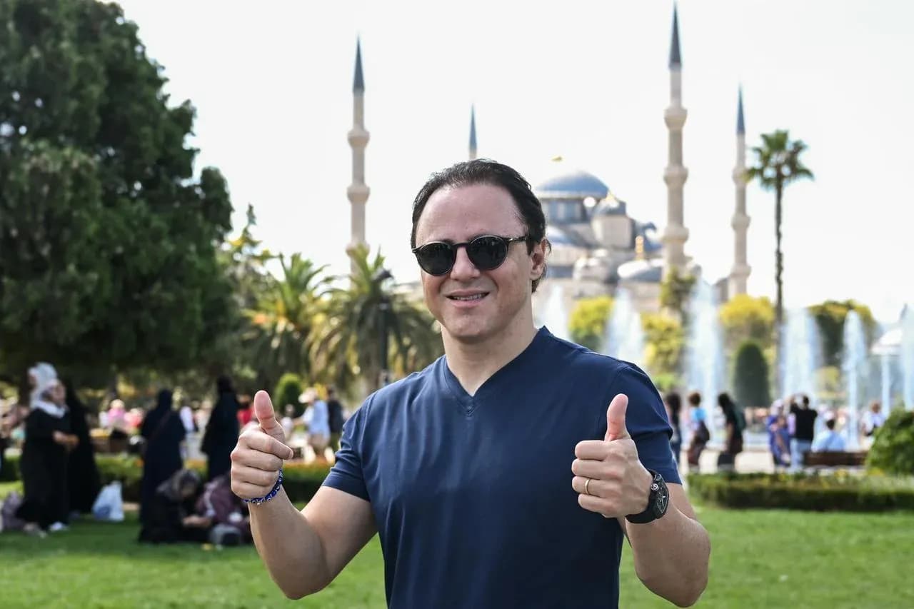 Hombre sonriente haciendo pulgar arriba en parque