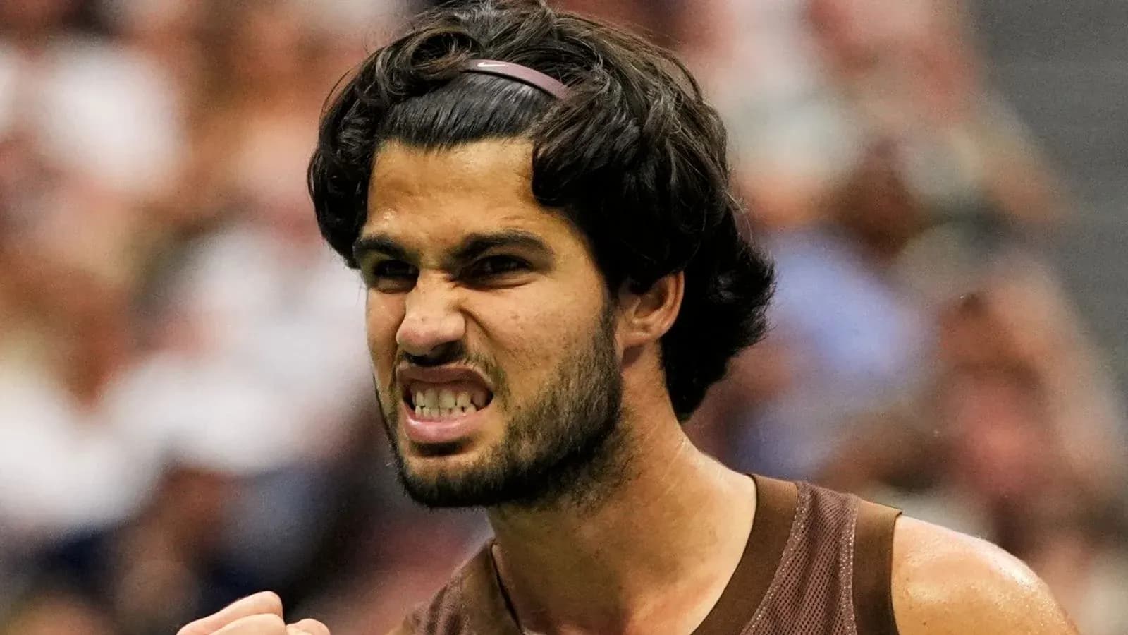 Jugador de tenis celebrando con gesto de determinación