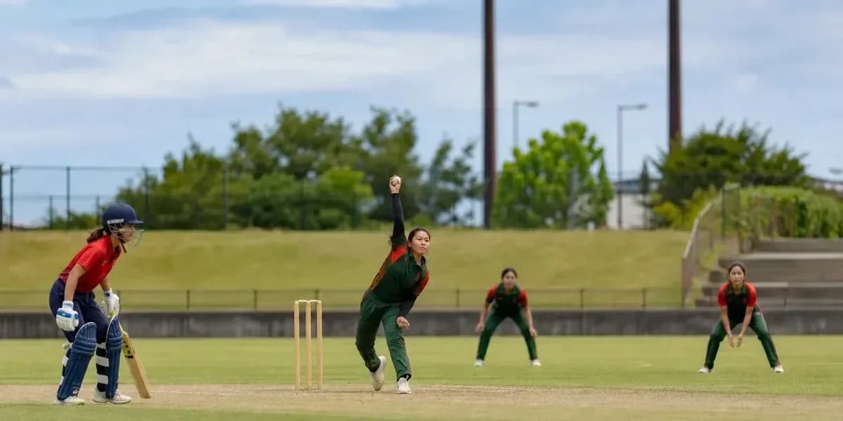 Jugadora lanzando en partido de cricket femenino