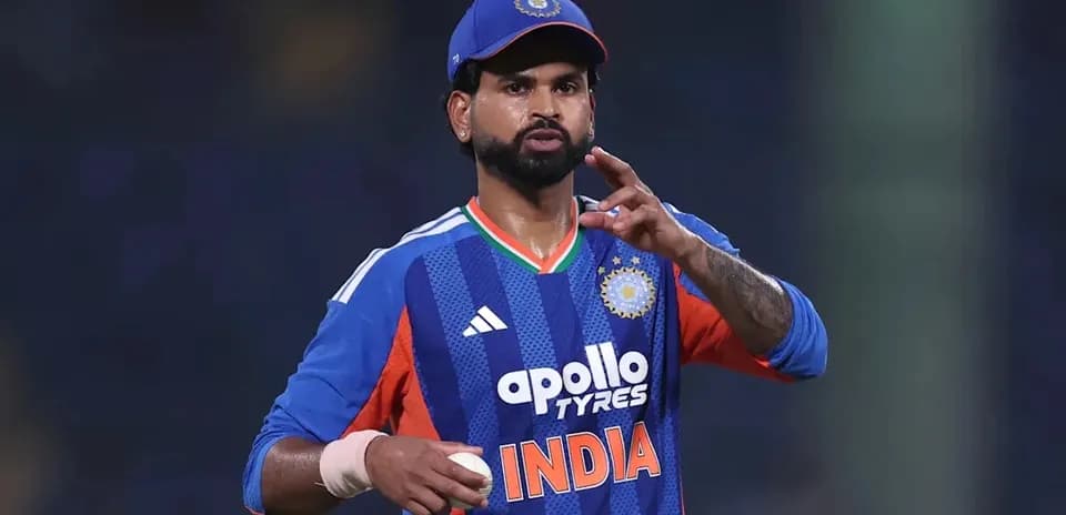 Jugador de cricket en uniforme de India señalando