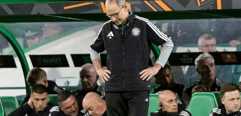 Entrenador mirando al suelo en el banquillo