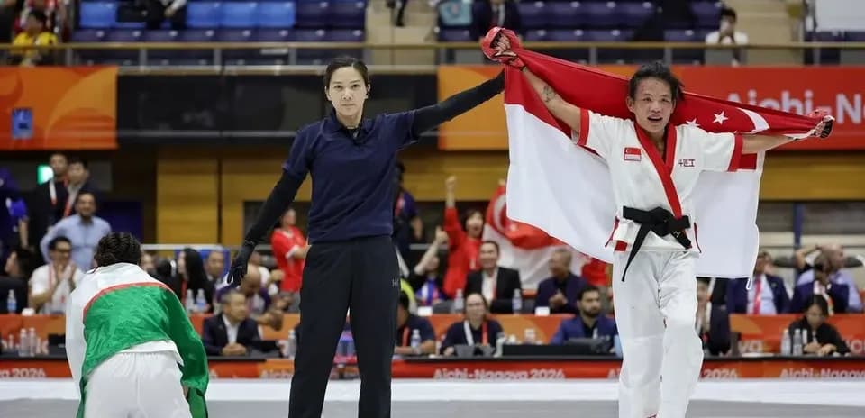 Competitor celebrating victory with national flag