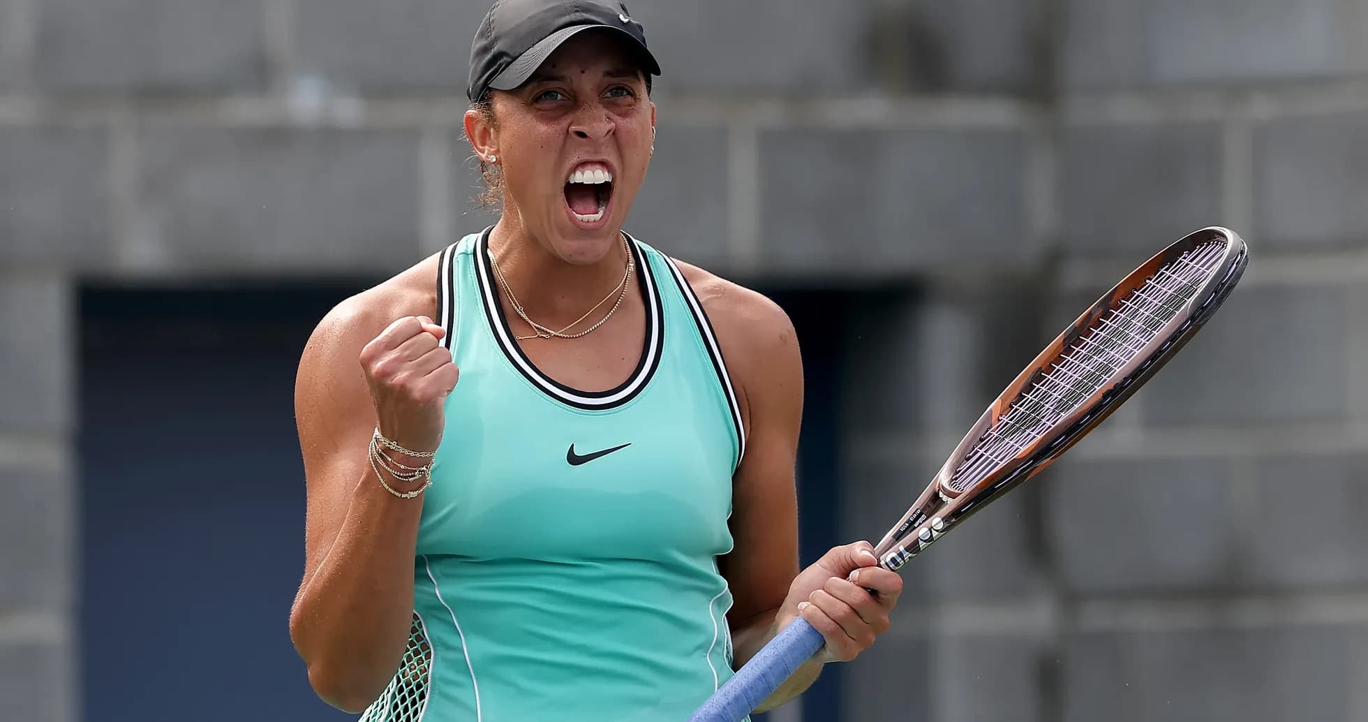 Jugadora de tenis celebrando con raqueta en mano