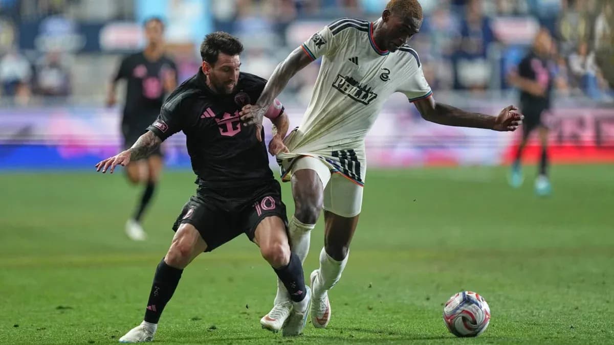 Lionel Messi and opponent contesting for the ball Lionel Messi and opponent contesting for the ball