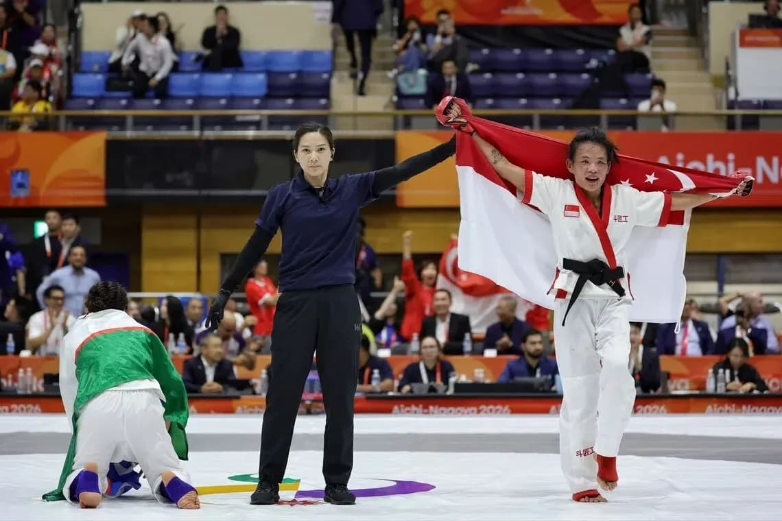 Competitor celebrating victory with national flag Competitor celebrating victory with national flag