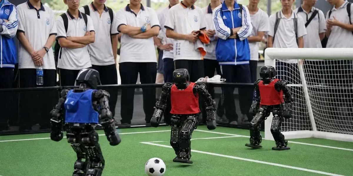 Robots playing soccer in front of spectators Robots playing soccer in front of spectators